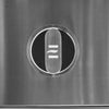 Close-up of an illuminated stainless steel grill control knob with a stylized emblem on a brushed control panel