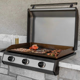 Blackstone 30-inch electric drop-in griddle with open lid cooking shrimp, lobster, and sausage on a marble outdoor counter
