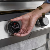 Close-up of a hand adjusting the LED digital temperature control knob to 400 degrees on a Blackstone electric drop-in griddle
