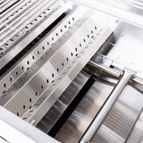Interior of a Summerset built-in gas grill showing the stainless steel flame tamer plates over the burner