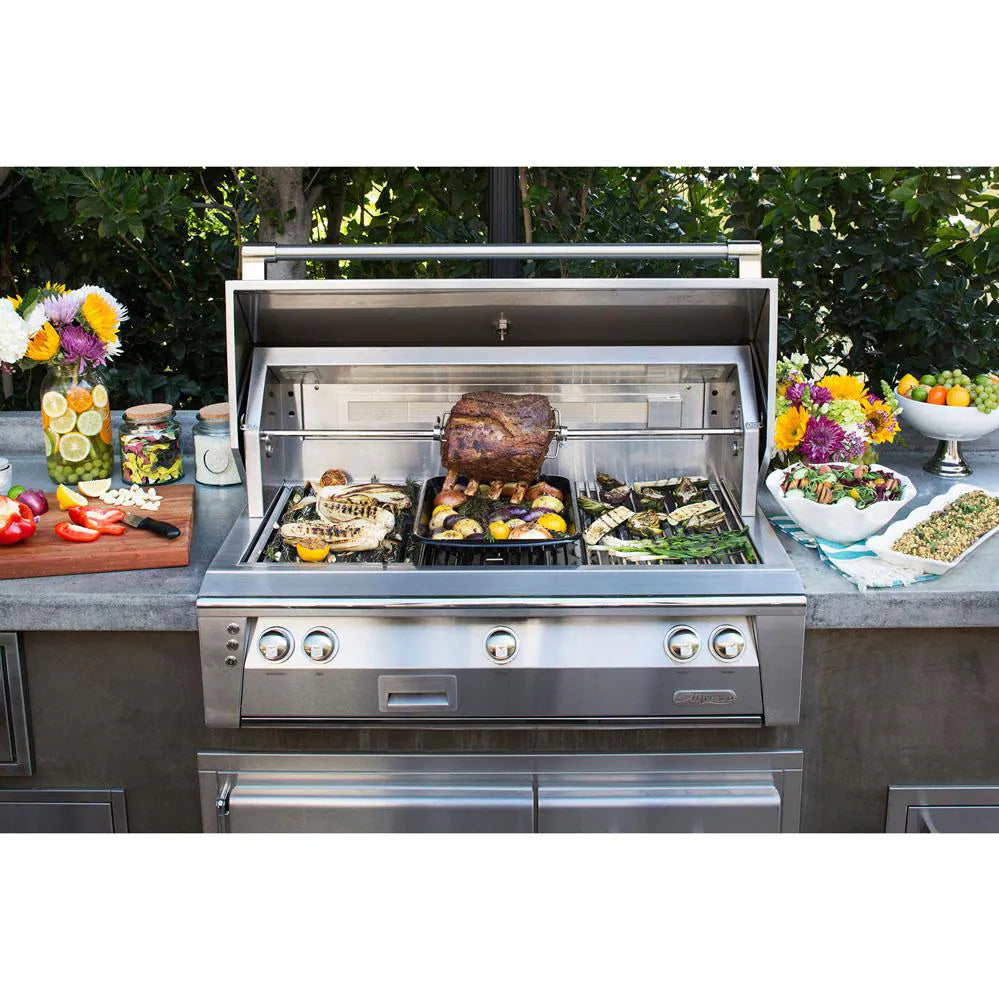 Alfresco freestanding gas grill cooking a roast and vegetables, surrounded by food platters in an outdoor patio