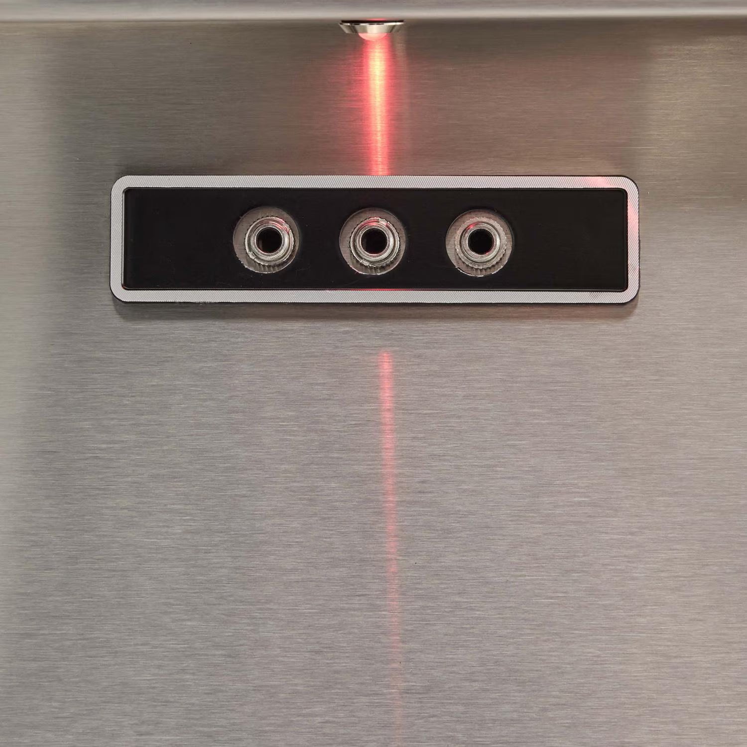 Close-up of Coyote grill ignition and light control buttons with LED indicator