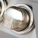 Close-up of a polished stainless steel control knob with an Alfresco logo on a built-in gas grill control panel