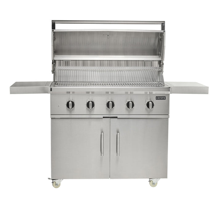 A stainless steel Coyote 42-inch C-Series freestanding gas grill on a cart, shown front-on with the lid open revealing the cooking grates, five control knobs, two folding side shelves, a double-door cabinet base on casters, and the Coyote logo, against a white background