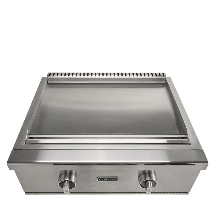 A stainless steel Coyote 30-inch built-in flat top gas griddle with the lid open showing the smooth flat cooking surface, two round control knobs and the Coyote logo on the front panel, shown front-on against a white background