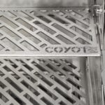 A close-up feature thumbnail of a stainless steel warming rack with a diagonal lattice pattern and the Coyote logo embossed in the center