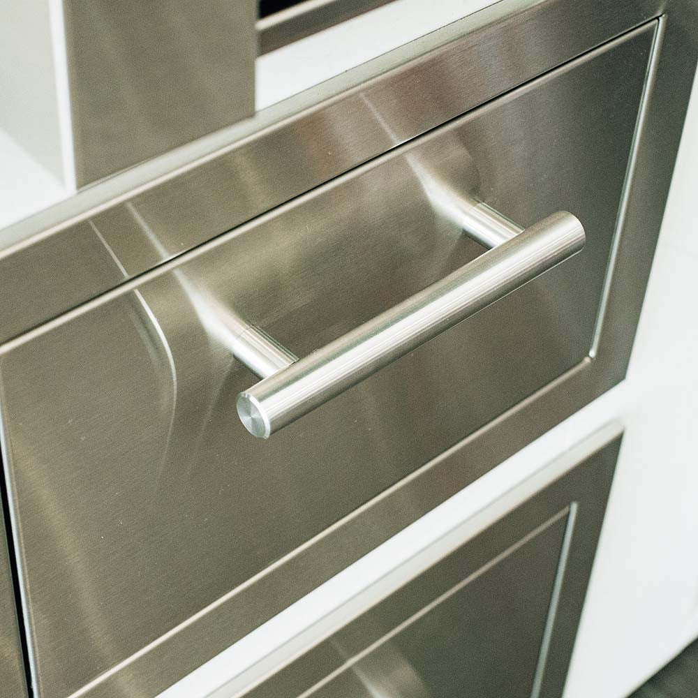 Close-up of a stainless steel built-in outdoor drawer face with a tubular bar handle