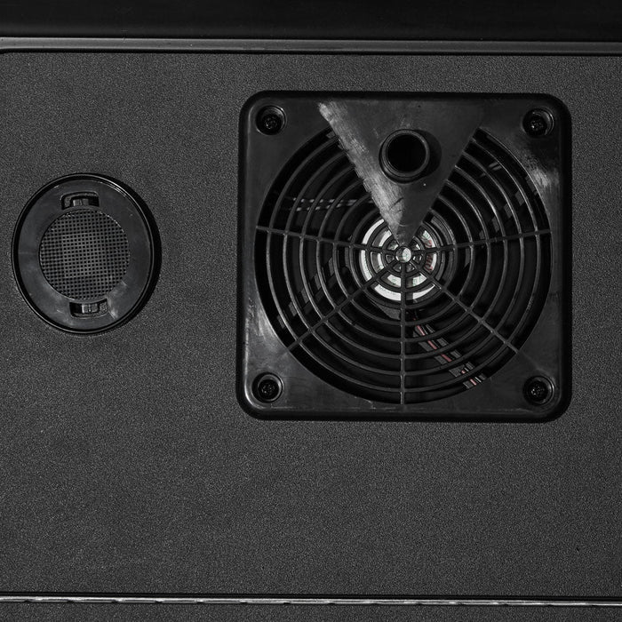 A close-up of the interior cooling fan inside the kegerator, a black square fan with a circular wire guard mounted on the dark back wall beside a round vent grommet