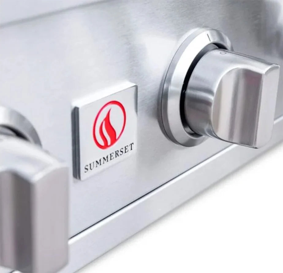 Close-up of the control panel with the Summerset flame logo badge and knobs of a Sizzler 32-inch built-in gas grill