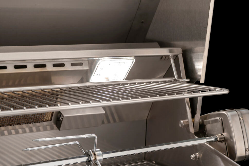 Close-up of an AOG built-in grill's illuminated interior lighting, cooking grates, and rotisserie rod