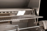 Close-up of an AOG built-in grill's illuminated interior lighting, cooking grates, and rotisserie rod