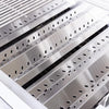 Close-up of a grill's stainless steel vented heat tents and flame tamers inside the firebox