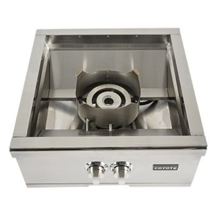 A stainless steel Coyote built-in power burner with the lid open showing the large round high-output burner inside the well, two control knobs and the Coyote logo on the front panel, shown from a front-elevated angle against a white background