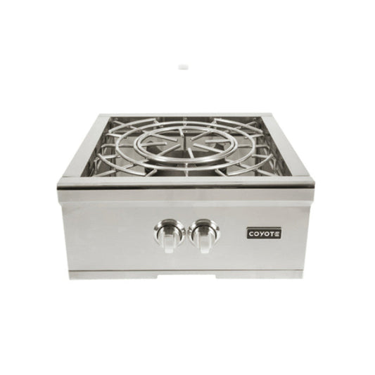 A stainless steel Coyote built-in power burner with the lid open showing a high-output round burner and grate, two control knobs and the Coyote logo on the front panel, shown at a slight angle against a white background