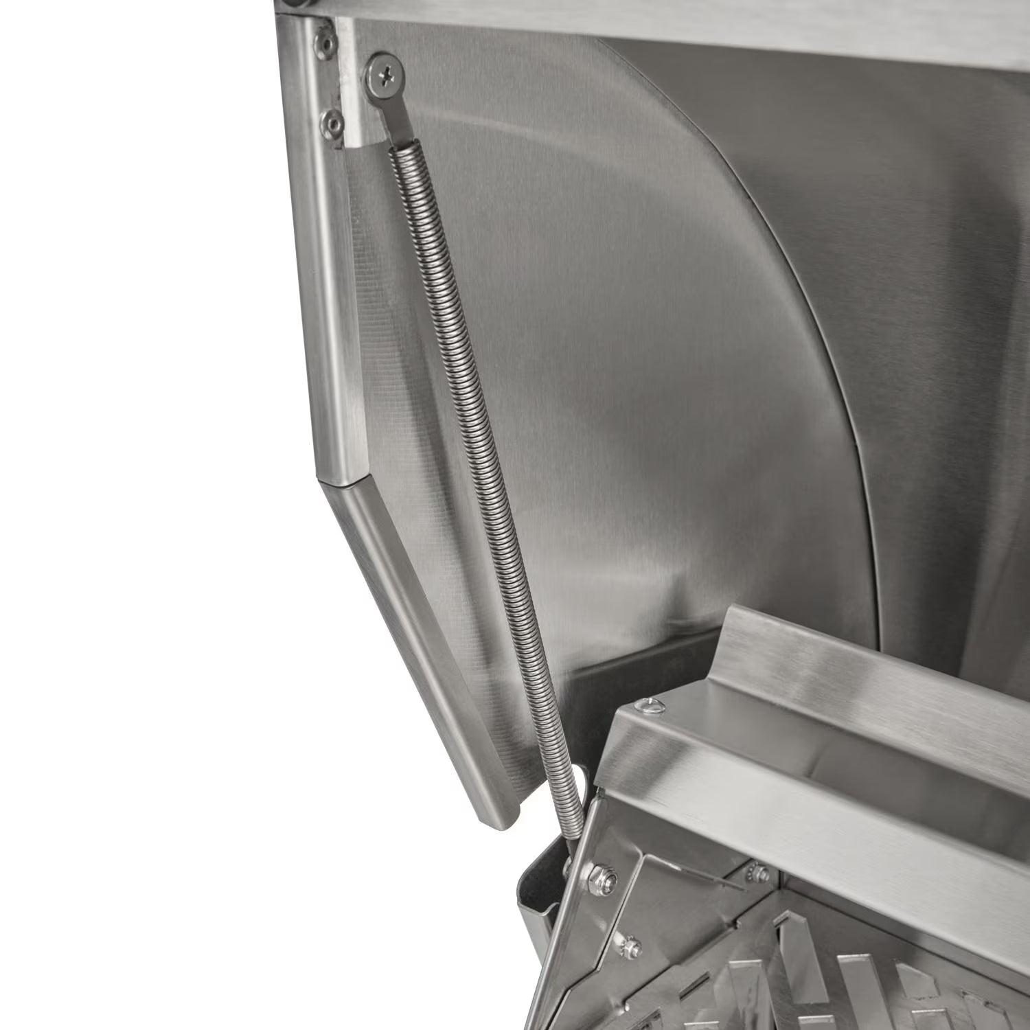 Close-up of a stainless steel grill lid hinge and its coil spring mechanism, with the firebox and cooking grates partly visible, on a white background