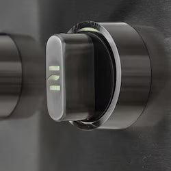 Close-up of a single stainless steel grill control knob on a grill control panel