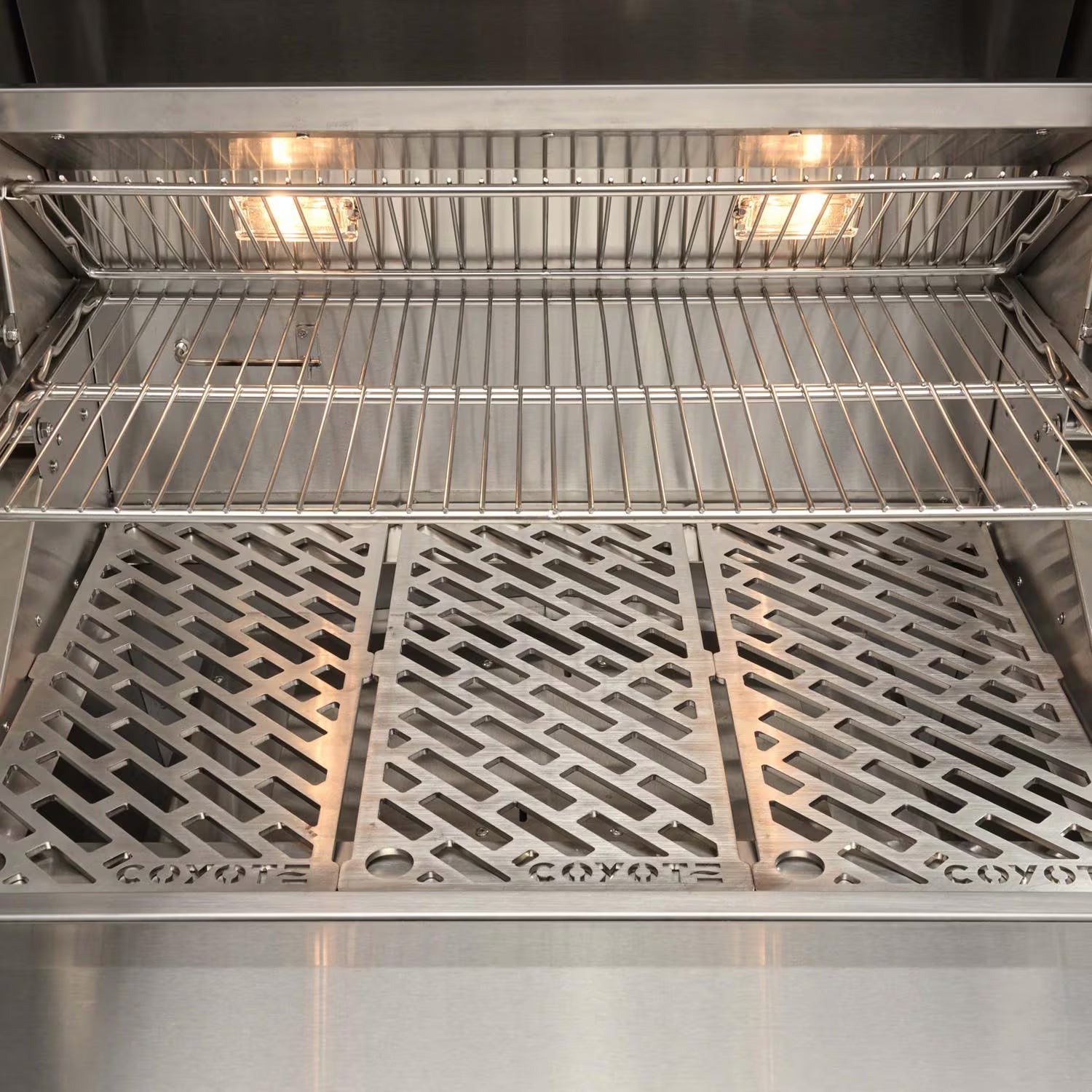 Illuminated firebox and cooking grates of Coyote C3C30 outdoor gas grill