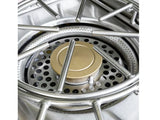 Close-up of a power burner's brass burner head, perforated bowl, and round cast iron grate