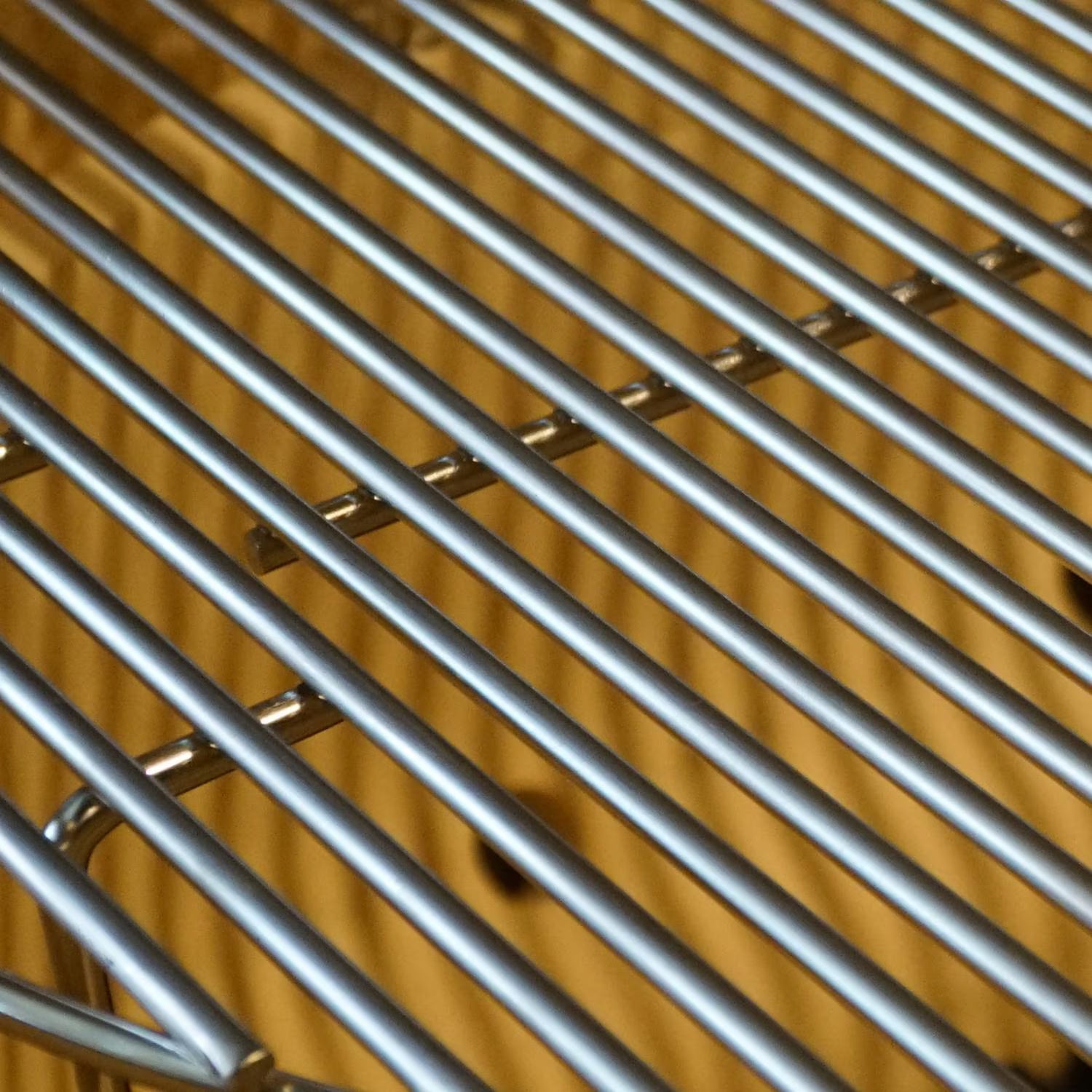 Close-up of the stainless steel cooking grate on the Primo Oval X-Large ceramic charcoal grill head, PGCXLH
