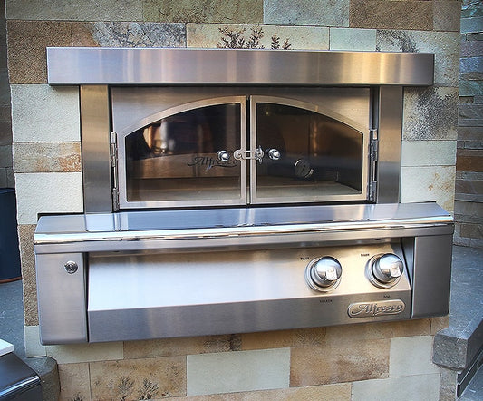 Alfresco Pizza Oven Plus built-in gas pizza oven shown on a pizza prep cart with cutting board and storage
