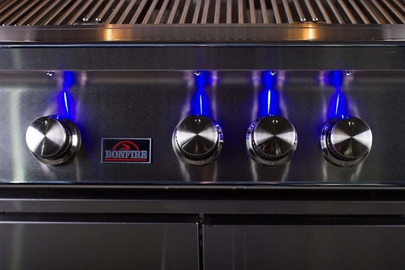 Bonfire 4 Drop-In Grill with rotisserie kit displayed in a modern outdoor kitchen setup, ideal for entertaining.