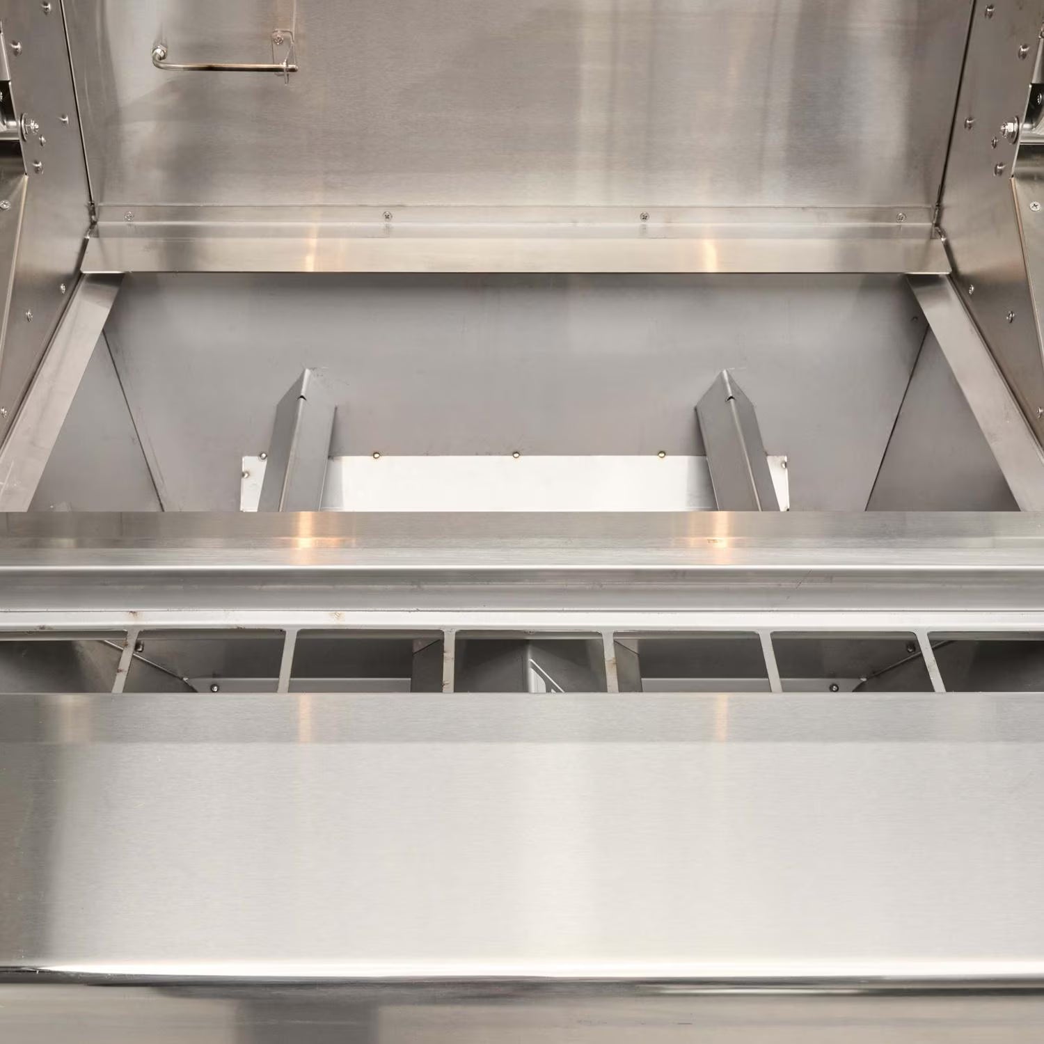 Interior firebox with stainless heat diffuser plate in Coyote outdoor grill