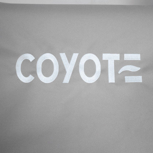 White Coyote logo detail on gray outdoor grill cover fabric