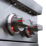 Angled close-up of a side burner's two stainless steel control knobs with red-illuminated bezels set to OFF