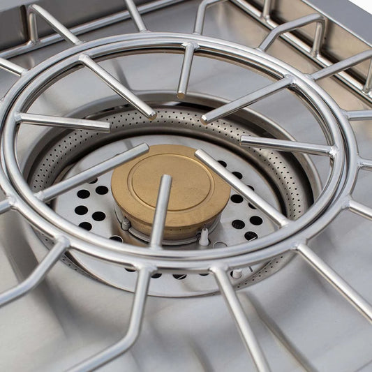 Close-up of the Atlas Power Burner dual-ring stainless steel burner and brass center cap with cast grate