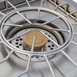 Close-up of the Atlas Power Burner dual-ring stainless steel burner and brass center cap with cast grate