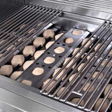 Close-up inside an RCS Premier grill firebox showing the tan ceramic briquettes seated in their metal trays beneath the stainless steel cooking grates