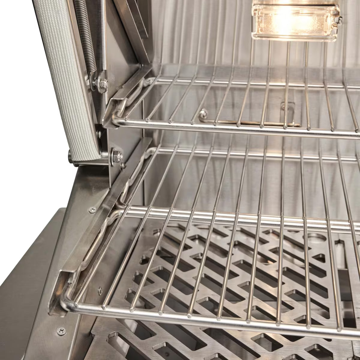 Angled interior view of Coyote C3C30 grill cooking grates with lights on
