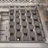 Interior of a Coyote grill showing rows of ceramic radiant briquette trays above the stainless steel burner channels