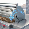 Stainless steel built-in grill with a curved blue animated arrow illustrating the smooth opening and closing motion of the hinged lid, shown in an outdoor setting