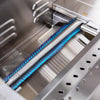Close-up of a lit stainless steel tube burner with blue flames inside a Summerset built-in gas grill