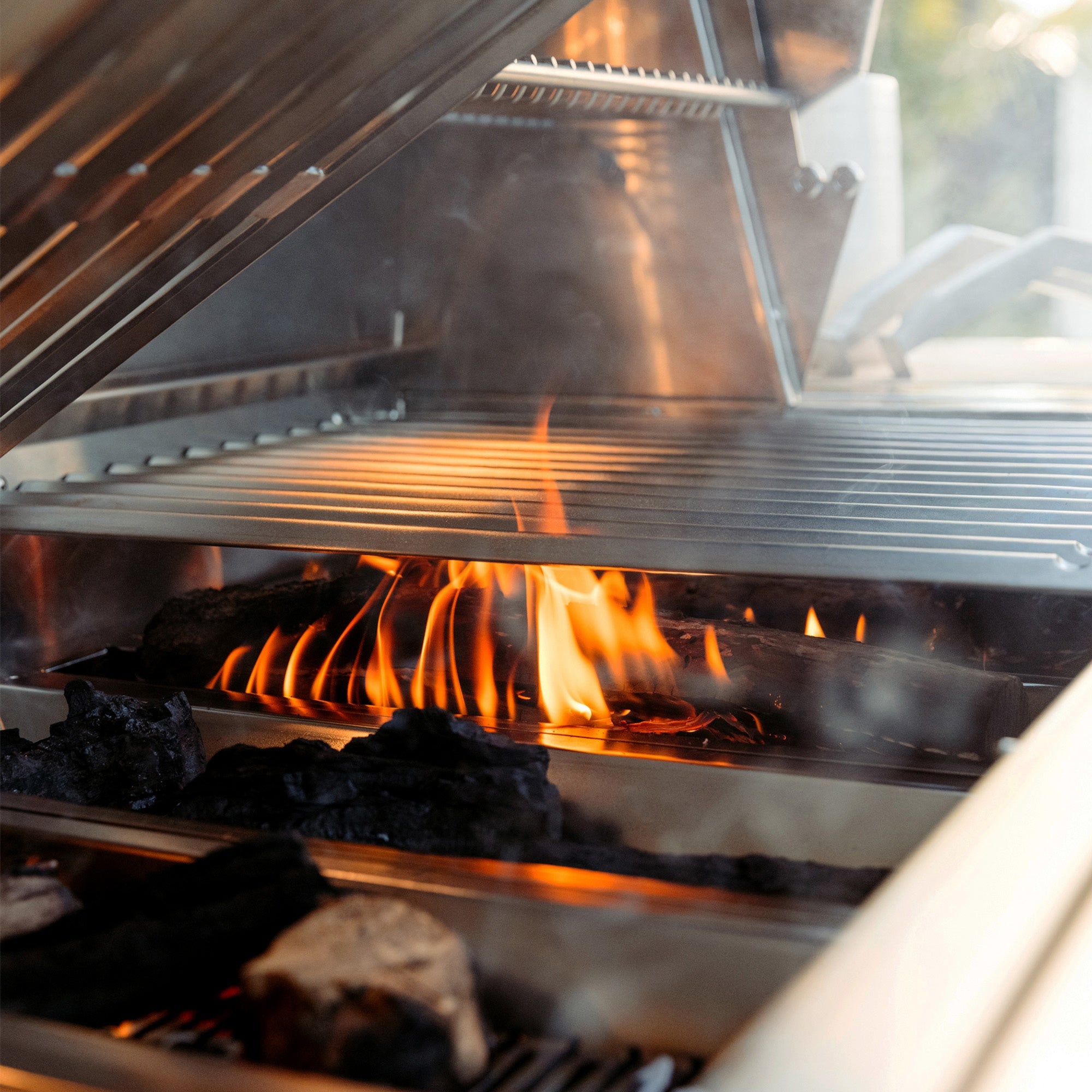 American Made Grills Encore 54-inch hybrid built-in grill — cooking grates over solid fuel