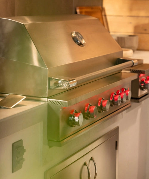 Coyote stainless steel built-in grill installed in an outdoor kitchen island