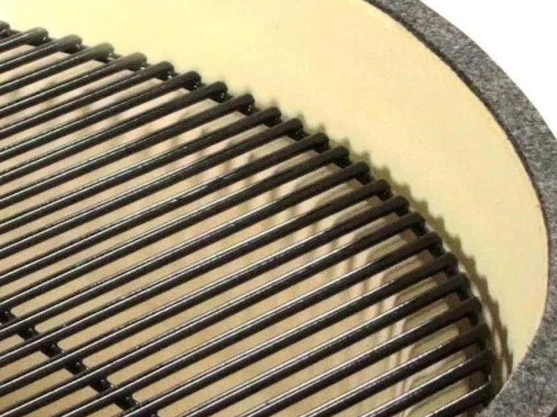 Stainless steel cooking grate seated in the ceramic firebox of the Primo Round ceramic charcoal grill head, PGCRH