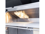 Close-up of a Summerset Sizzler Pro grill interior showing the lit halogen interior light and warming rack